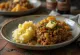 Haggis με neeps και tatties σερβιρισμένο, διακοσμημένο με πλούσιο πουρέ και φρέσκα μυρωδικά