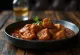 Vindaloo με χοιρινό, σερβιρισμένο σε πικάντικη σάλτσα
